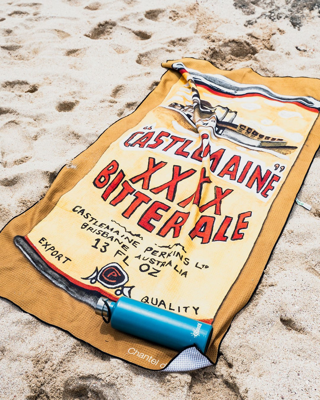Castlemaine XXXX ECO beach towel at the beach