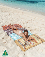 Castlemaine XXXX and Tribal Blue ECO beach towels on the sand