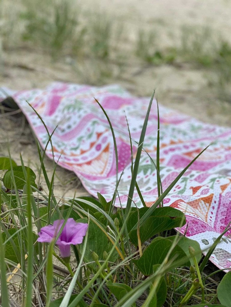Tribal Pink ECO beach towel on the sand